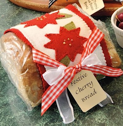 festive cherry bread recipe with poinsettia gift wrap